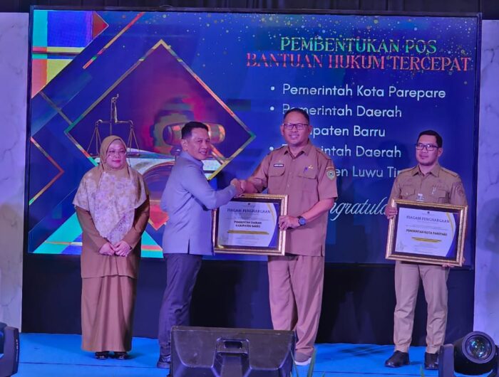Pejabat Pemkab Barru menerima Piagam Penghargaan Pos Bantuan Hukum Tercepat Kedua dari Kanwil Kemenkumham Sulawesi Selatan di Aula Pancasila Makassar
